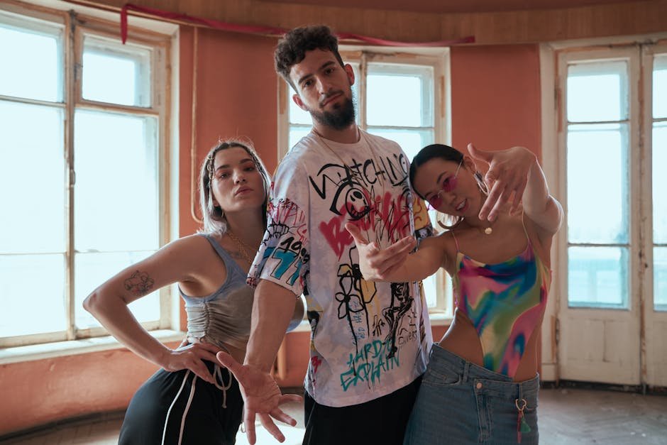 A group of fashionable young adults posing energetically in a bright indoor setting.